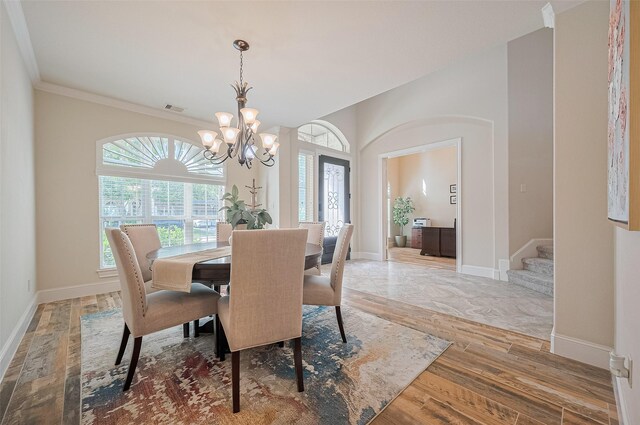 27815 Carol Collier Ct, Katy, TX 77494 - dining area with healthy amount of natural light, light wood-style flooring, stairway, and ornamental molding