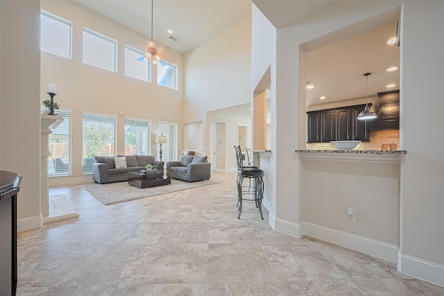 27815 Carol Collier Ct, Katy, TX 77494 - living area with plenty of natural light, a high ceiling, and ceiling fan