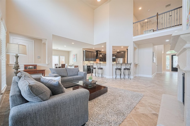 27815 Carol Collier Ct, Katy, TX 77494 - living room featuring healthy amount of natural light, a high ceiling, a fireplace, and recessed lighting