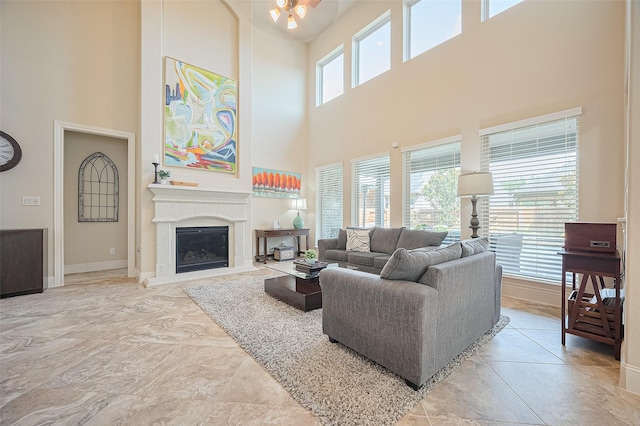 27815 Carol Collier Ct, Katy, TX 77494 - living area with a high ceiling, a glass covered fireplace, and ceiling fan