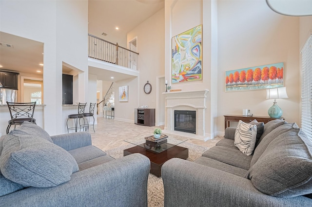 27815 Carol Collier Ct, Katy, TX 77494 - living room featuring a high ceiling, stairway, a glass covered fireplace, and recessed lighting