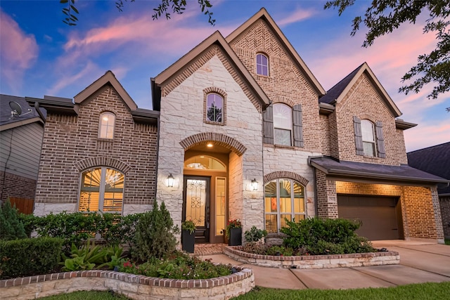 27815 Carol Collier Ct, Katy, TX 77494 - french provincial home with brick siding, an attached garage, concrete driveway, and stone siding