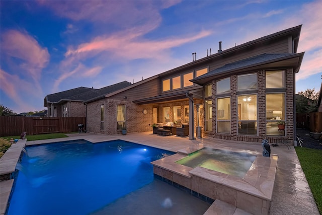 27815 Carol Collier Ct, Katy, TX 77494 - back of house with an in-ground hot tub, a fenced backyard, a patio, outdoor lounge area, and brick siding