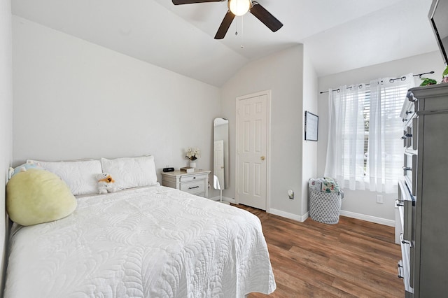 3902 Cary Creek Dr, Baytown, TX 77521 - bedroom with vaulted ceiling, dark wood-style floors, baseboards, and ceiling fan