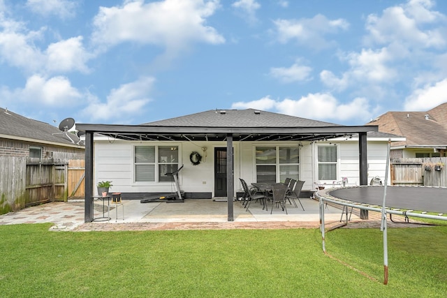 3902 Cary Creek Dr, Baytown, TX 77521 - back of house featuring a patio, a trampoline, and a shingled roof