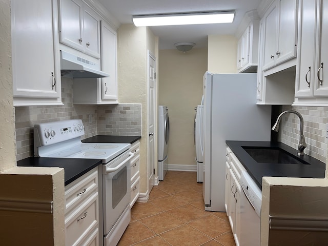 14515 Wunderlich Dr Unit 1703, Houston, TX 77069 - kitchen with white appliances, a sink, under cabinet range hood, washer and clothes dryer, and decorative backsplash