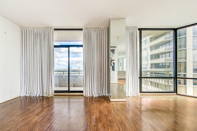 14 Greenway Plz Unit 19P, Houston, TX 77046 - empty room featuring expansive windows and wood finished floors