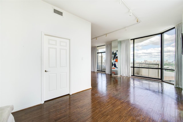14 Greenway Plz Unit 19P, Houston, TX 77046 - empty room featuring track lighting, wood finished floors, and expansive windows