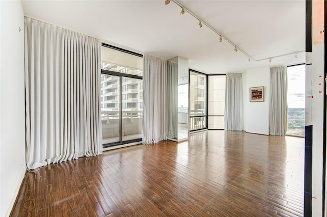 14 Greenway Plz Unit 19P, Houston, TX 77046 - unfurnished room featuring a wall of windows, track lighting, and wood finished floors