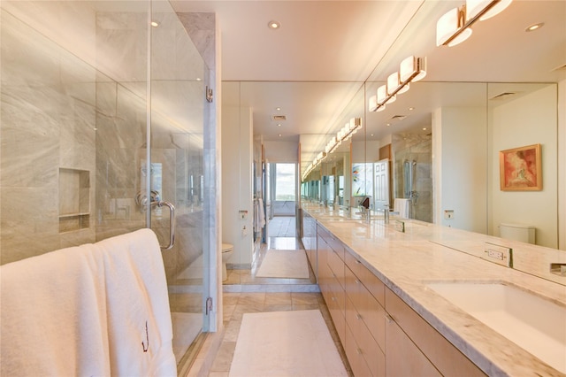 14 Greenway Plz Unit 19P, Houston, TX 77046 - bathroom featuring double vanity, a stall shower, and recessed lighting