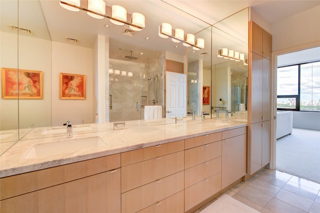 14 Greenway Plz Unit 19P, Houston, TX 77046 - bathroom with a shower stall, double vanity, and tile patterned floors