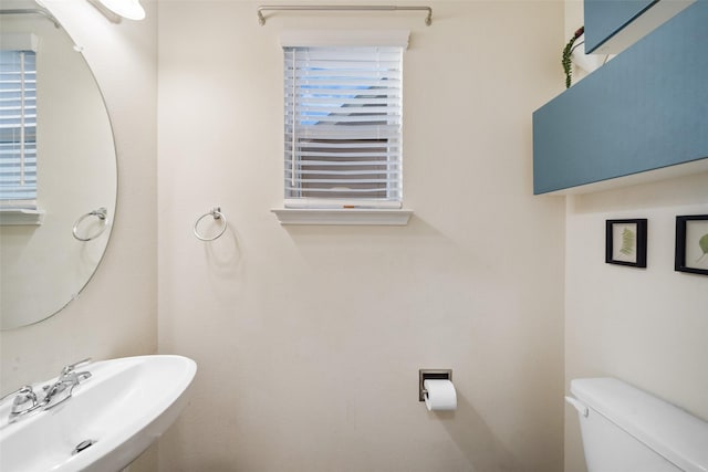 15207 Lake Powell Dr, Humble, TX 77396 - half bath featuring a sink, toilet, and plenty of natural light