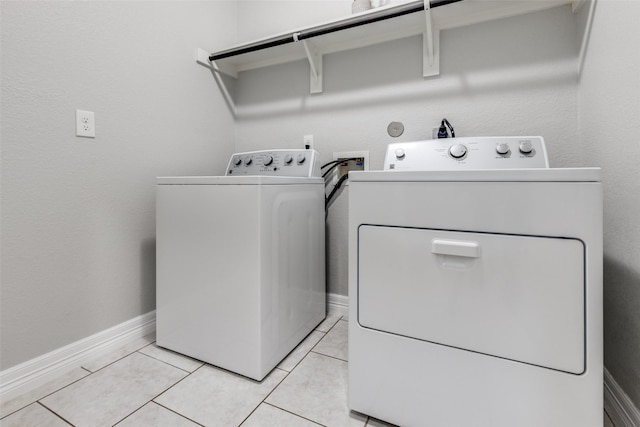 619 Palo Alto Ct, Rosharon, TX 77583 - washroom with washing machine and clothes dryer, baseboards, and light tile patterned flooring