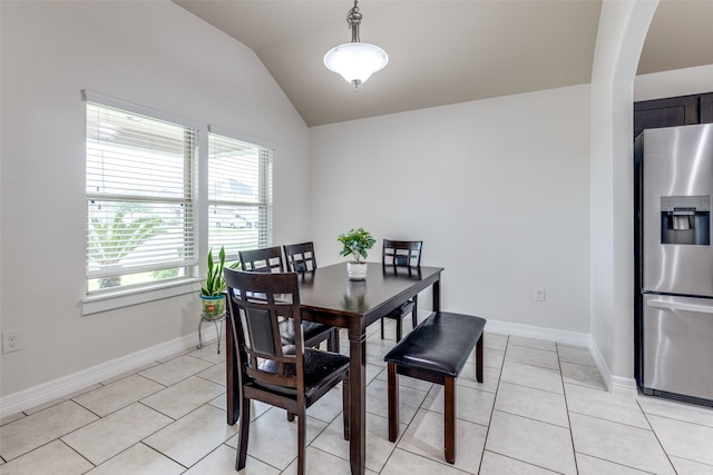 619 Palo Alto Ct, Rosharon, TX 77583 - dining room with healthy amount of natural light, arched walkways, lofted ceiling, light tile patterned floors, and baseboards