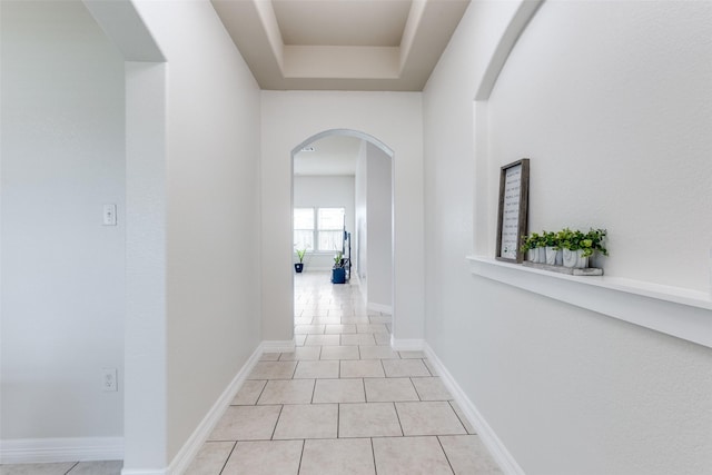 619 Palo Alto Ct, Rosharon, TX 77583 - hallway featuring arched walkways, light tile patterned floors, and a raised ceiling