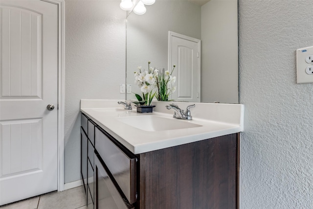 619 Palo Alto Ct, Rosharon, TX 77583 - bathroom with double vanity, a textured wall, and tile patterned floors