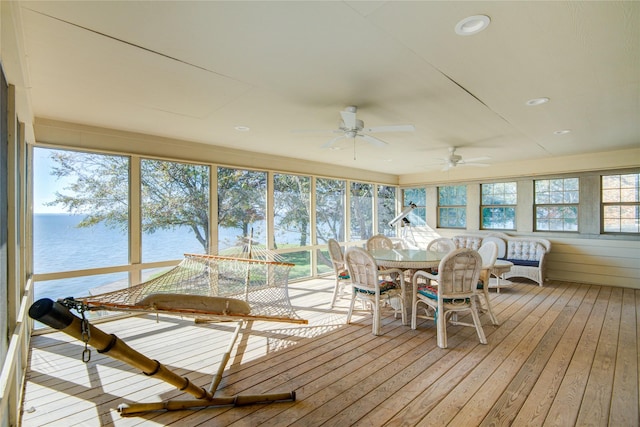 409 Wildwood Dr, Onalaska, TX 77360 - sunroom featuring wood-type flooring, ceiling fan, outdoor dining space, and a deck with water view