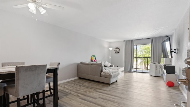 212 Plaza Verde Dr Unit F-22, Houston, TX 77038 - living room featuring light wood-style flooring, baseboards, and ceiling fan