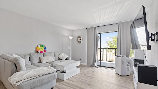 212 Plaza Verde Dr Unit F-22, Houston, TX 77038 - living area featuring light wood-style flooring and baseboards