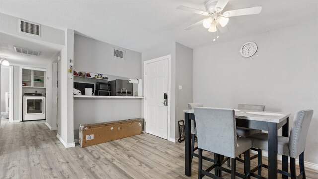 212 Plaza Verde Dr Unit F-22, Houston, TX 77038 - dining room featuring washer / clothes dryer, ceiling fan, and wood finished floors