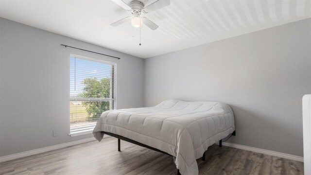 212 Plaza Verde Dr Unit F-22, Houston, TX 77038 - bedroom with baseboards, wood finished floors, and a ceiling fan