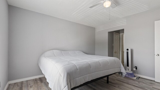 212 Plaza Verde Dr Unit F-22, Houston, TX 77038 - bedroom featuring baseboards, wood finished floors, and a ceiling fan