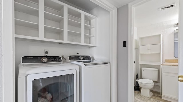 212 Plaza Verde Dr Unit F-22, Houston, TX 77038 - laundry area featuring washer and dryer and light wood-type flooring