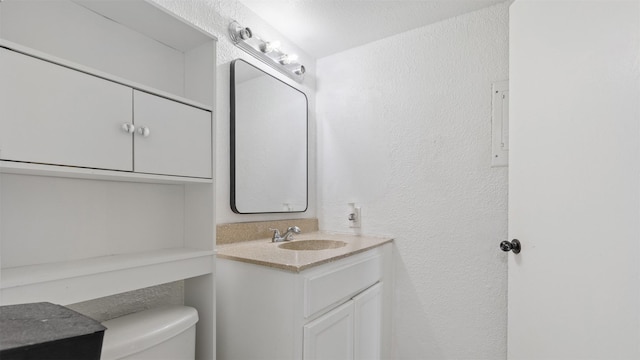 212 Plaza Verde Dr Unit F-22, Houston, TX 77038 - half bath featuring vanity, toilet, and a textured wall