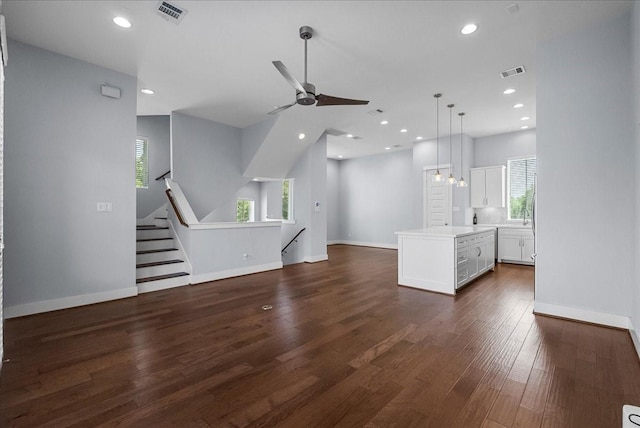 2607 Mcilhenny St, Houston, TX 77004 - unfurnished living room featuring healthy amount of natural light, ceiling fan, dark wood-style floors, baseboards, and recessed lighting