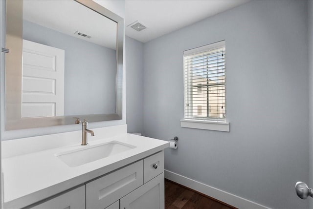 2607 Mcilhenny St, Houston, TX 77004 - bathroom featuring baseboards, vanity, and wood finished floors