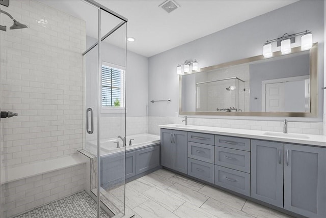 2607 Mcilhenny St, Houston, TX 77004 - bathroom featuring a garden tub, double vanity, a stall shower, marble look tiles, and recessed lighting