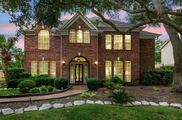 3815 Griffin Ln, Missouri City, TX 77459 - colonial-style house with brick siding, french doors, and a shingled roof