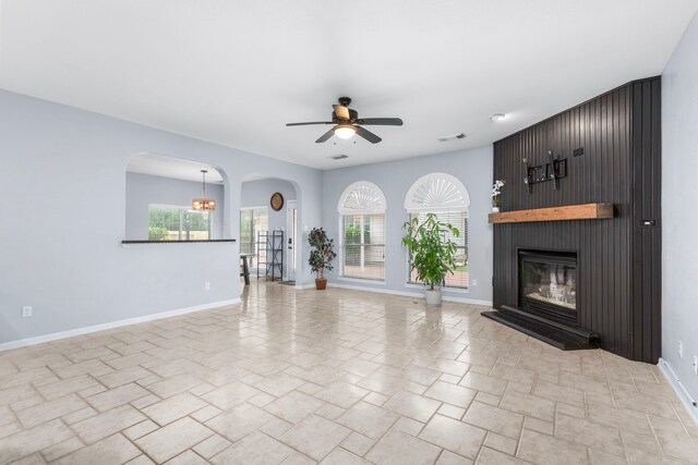 3815 Griffin Ln, Missouri City, TX 77459 - unfurnished living room with ceiling fan, baseboards, a large fireplace, and healthy amount of natural light