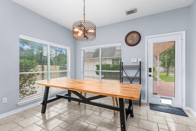 3815 Griffin Ln, Missouri City, TX 77459 - dining space featuring a chandelier, baseboards, and stone tile flooring