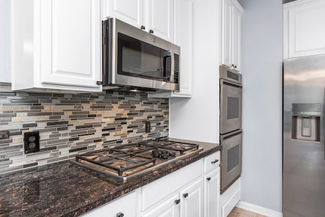3815 Griffin Ln, Missouri City, TX 77459 - kitchen with appliances with stainless steel finishes, white cabinetry, tasteful backsplash, and dark stone countertops