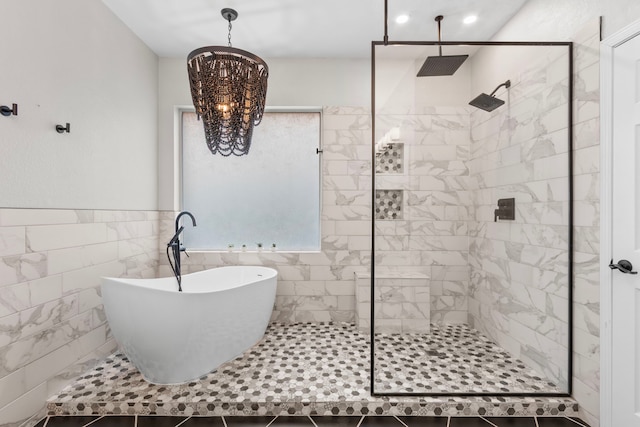 3815 Griffin Ln, Missouri City, TX 77459 - bathroom featuring a chandelier, tiled shower, a freestanding bath, tile walls, and wainscoting