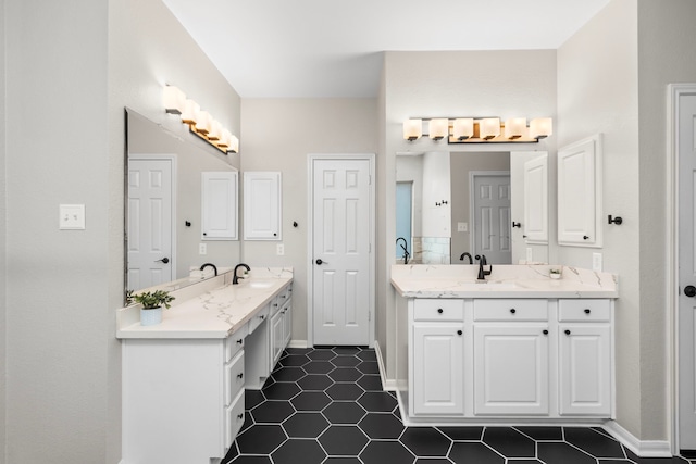3815 Griffin Ln, Missouri City, TX 77459 - bathroom with two vanities, tile patterned floors, and baseboards