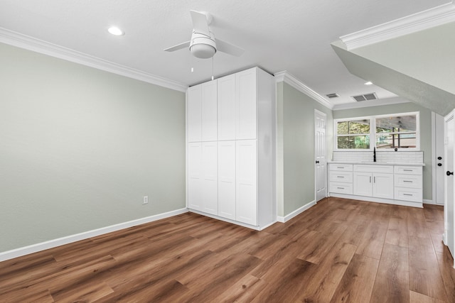 3815 Griffin Ln, Missouri City, TX 77459 - unfurnished bedroom with crown molding, baseboards, wood finished floors, a sink, and recessed lighting