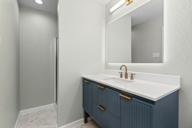 3815 Griffin Ln, Missouri City, TX 77459 - full bath featuring marble finish floors, vanity, a shower stall, and baseboards