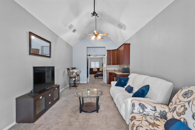 1012 Walnut Pointe, League City, TX 77573 - living area with light colored carpet, a ceiling fan, high vaulted ceiling, and baseboards