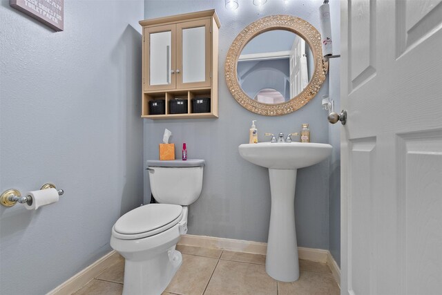 1012 Walnut Pointe, League City, TX 77573 - bathroom featuring tile patterned flooring, toilet, and baseboards