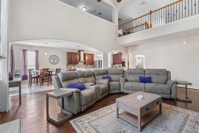 1012 Walnut Pointe, League City, TX 77573 - living area with arched walkways, a high ceiling, hardwood / wood-style flooring, and ceiling fan