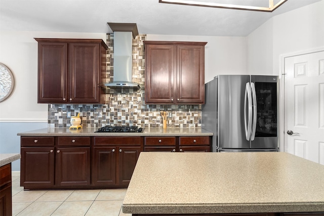 1012 Walnut Pointe, League City, TX 77573 - kitchen with freestanding refrigerator, wall chimney exhaust hood, tasteful backsplash, light countertops, and black gas stovetop