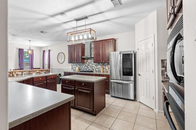 1012 Walnut Pointe, League City, TX 77573 - kitchen with smart refrigerator, black gas cooktop, wall chimney range hood, tasteful backsplash, and light tile patterned floors