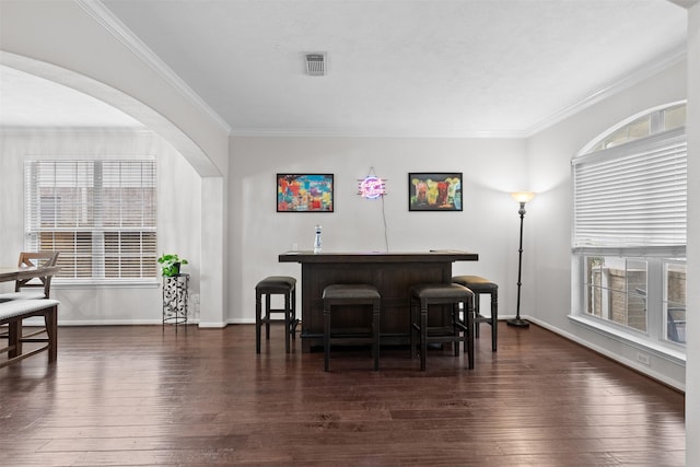 1012 Walnut Pointe, League City, TX 77573 - bar featuring plenty of natural light, crown molding, dark wood finished floors, and baseboards
