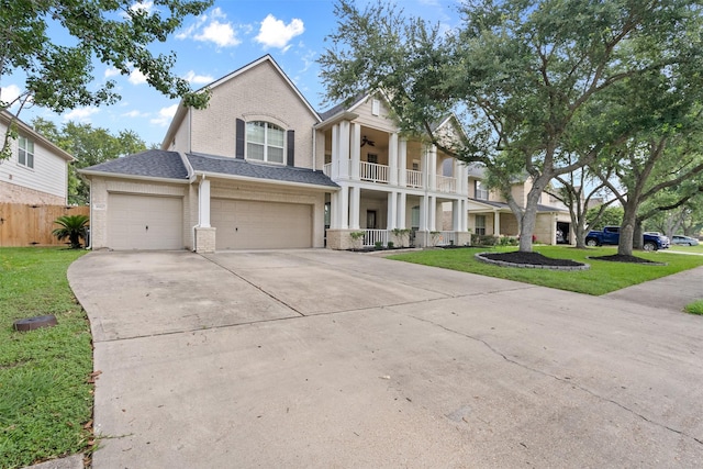 1012 Walnut Pointe, League City, TX 77573 - greek revival house with brick siding, concrete driveway, a balcony, ceiling fan, and an attached garage
