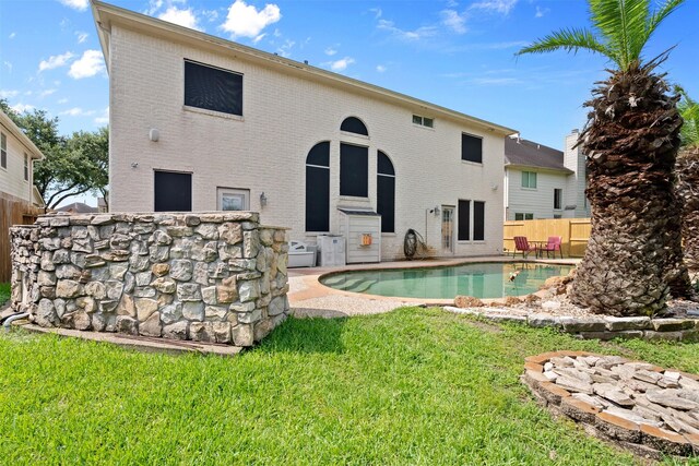 1012 Walnut Pointe, League City, TX 77573 - back of house featuring brick siding, an outdoor pool, and a patio area