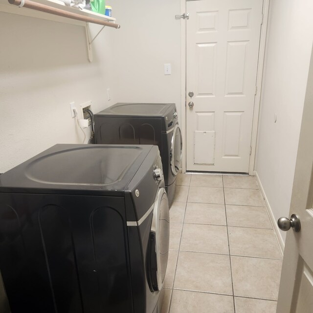1012 Walnut Pointe, League City, TX 77573 - laundry room with washing machine and dryer and light tile patterned flooring