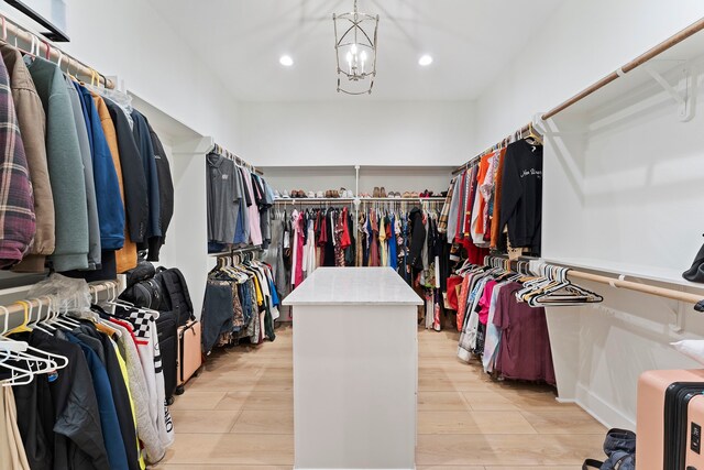 567 Lonestar Rd, Huntsville, TX 77340 - spacious closet featuring light wood finished floors and a chandelier