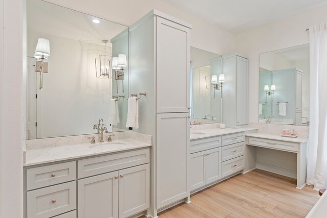 567 Lonestar Rd, Huntsville, TX 77340 - bathroom featuring two vanities and wood finished floors